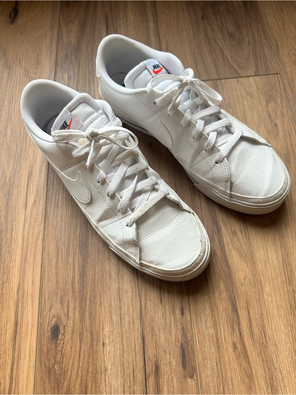 Nike White Low-Top Leather Sneakers with Subtle Orange Logo